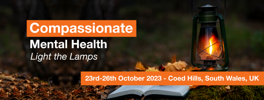 Banner with words Compassionate Mental Health Light the Lamps 23-26 October 2023, Coed Hills, South Wales, UK. An image of a lantern on the floor of a wood with autumn leaves and a book open on the ground, scattered with leaves.