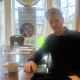 Arnaud Vallet with a compassionate mental health banner behind him