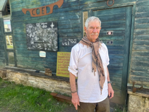 Barry stands in front of a map of coed
