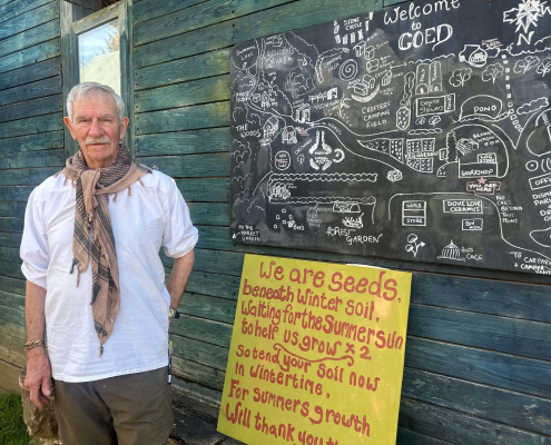 Barry stand in front of a map of Coed and a yellow board saying we are all seeds