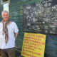 Barry stand in front of a map of Coed and a yellow board saying we are all seeds