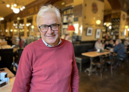 Roberto Mezzina wearing a pink jumper and smiling at the camera