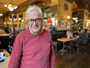 Roberto Mezzina wearing a pink jumper and smiling at the camera