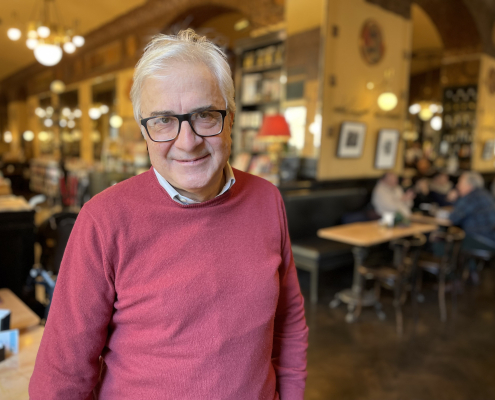 Roberto Mezzina wearing a pink jumper and smiling at the camera
