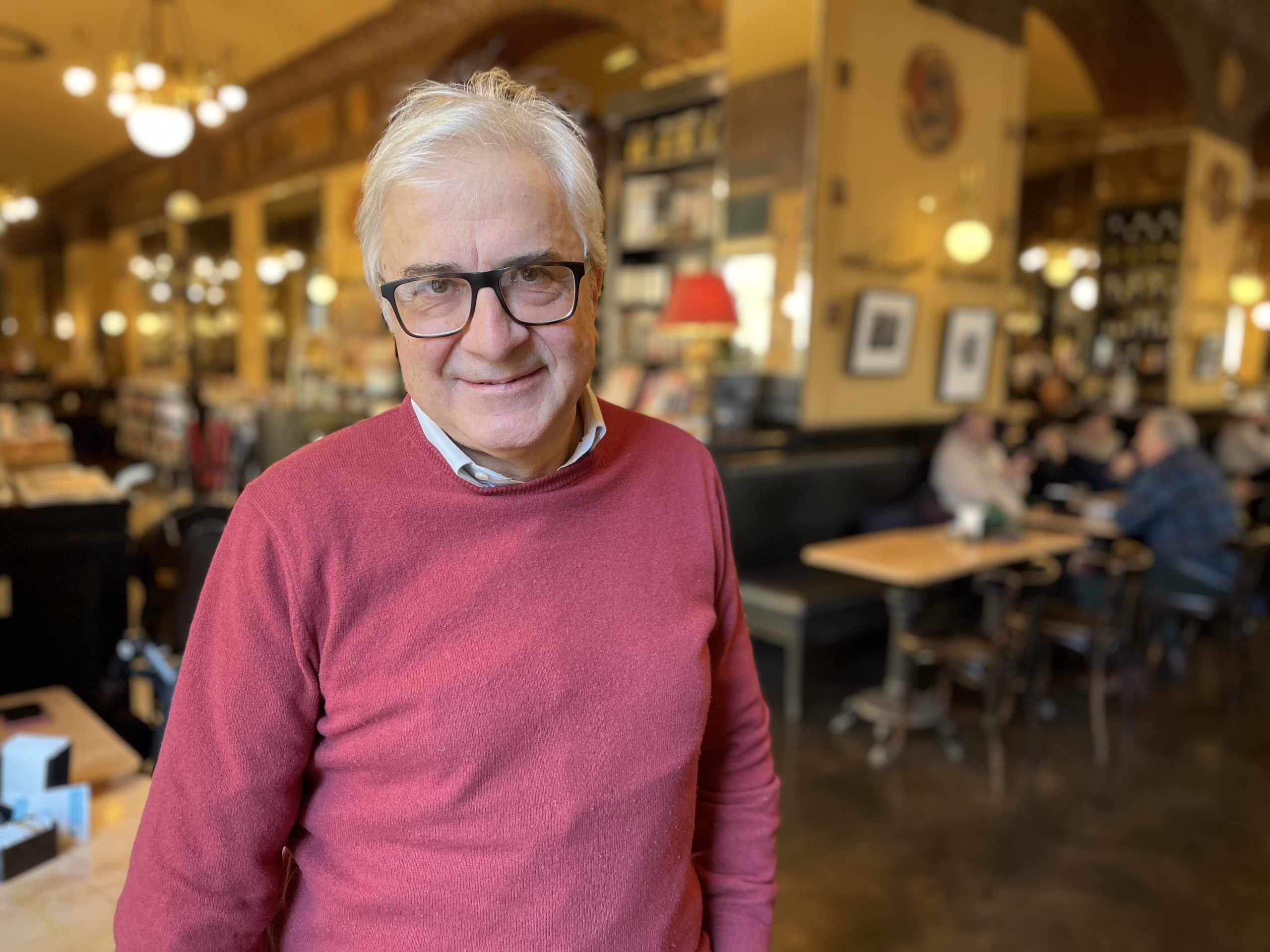 Roberto Mezzina wearing a pink jumper and smiling at the camera