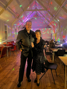 Steve and Chris with disco lights behind them