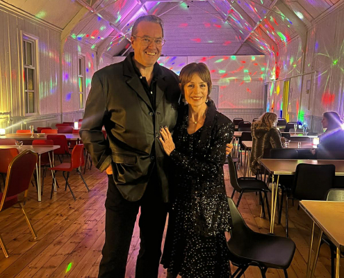 Steve and Chris with disco lights behind them